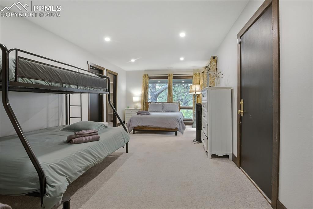 Image 40 of 50: Bedroom featuring light colored carpet and recessed lighting