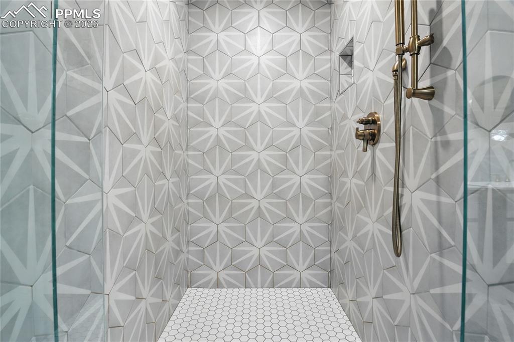 Image 43 of 50: Full bath featuring a tile shower