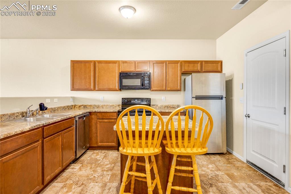 Image 10 of 32: Functional kitchen with ample storage, stainless appliances, and natural li