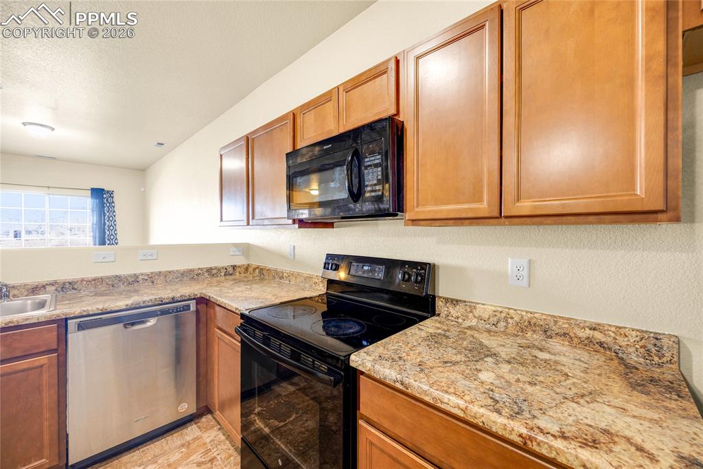 Image 12 of 32: Modern U-shaped layout with plenty of counter space for cooking and prep.
