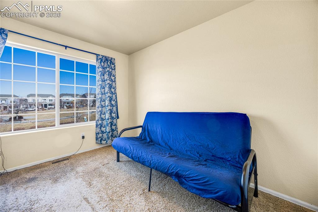 Image 24 of 32: Third bedroom with large window and mountain backdrop for added daylight.
