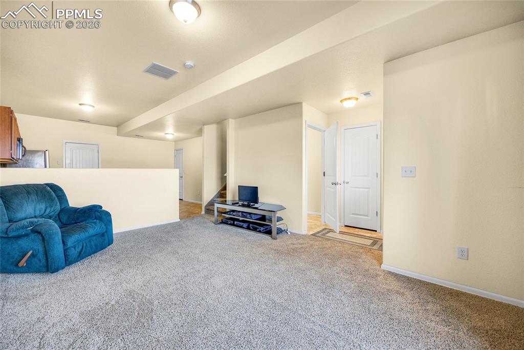 Image 5 of 32: Bright main living area with neutral tones and plenty of natural light.