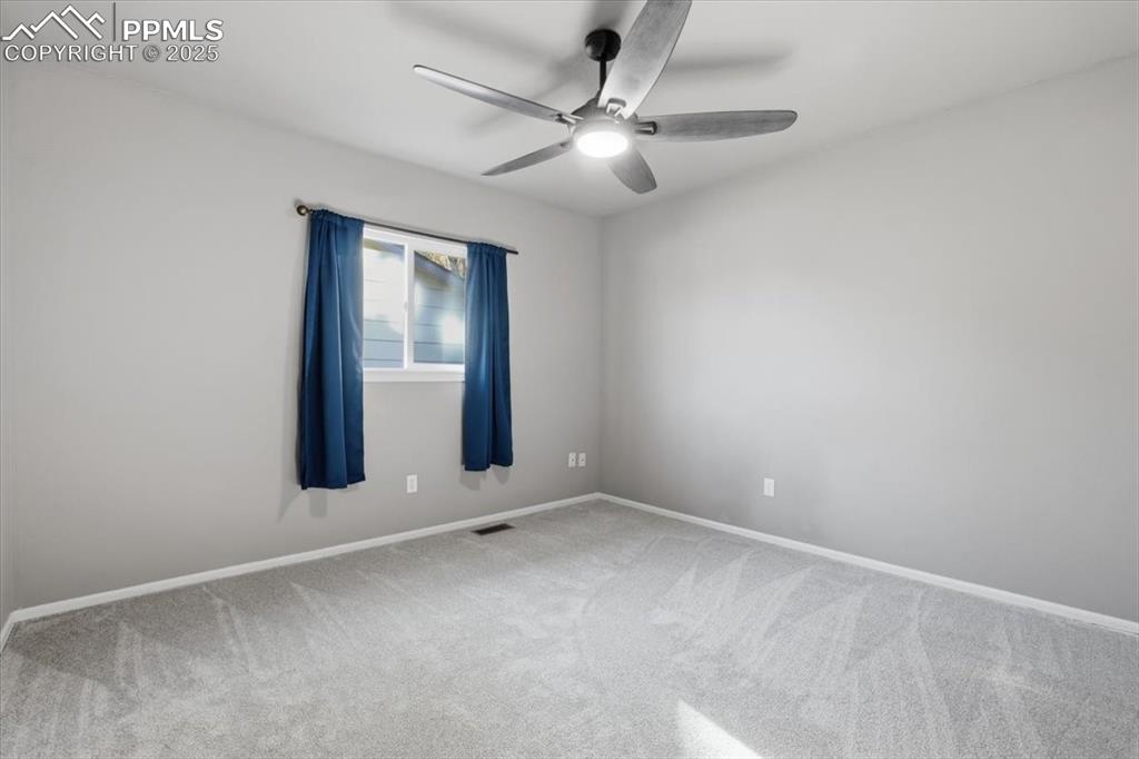 Image 28 of 48: Carpeted spare room featuring baseboards and a ceiling fan