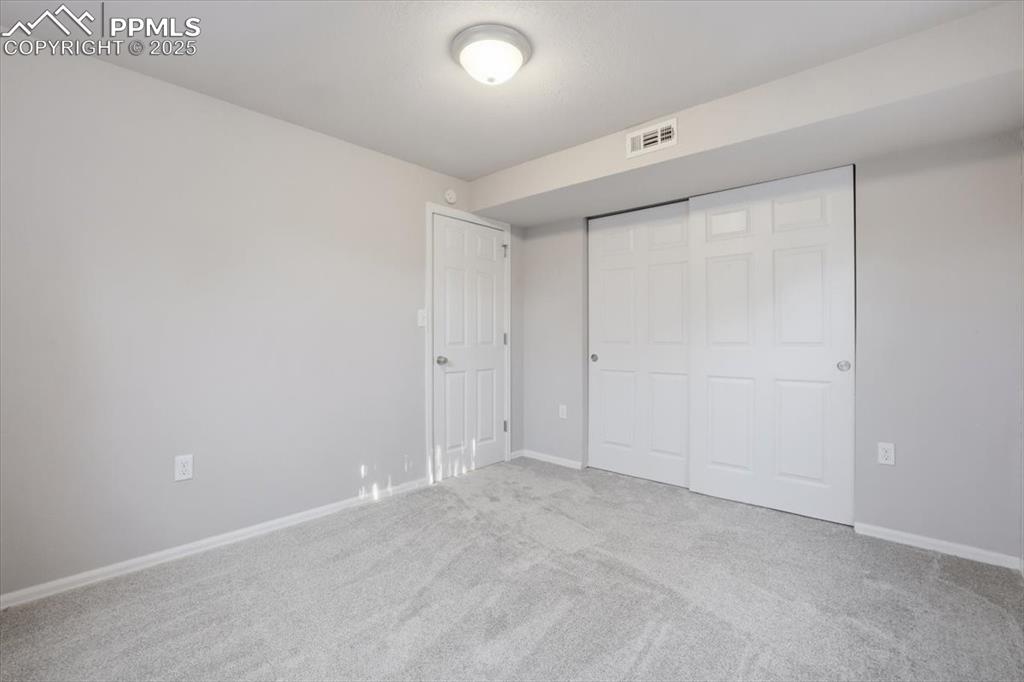 Image 39 of 48: Unfurnished bedroom featuring carpet and a closet