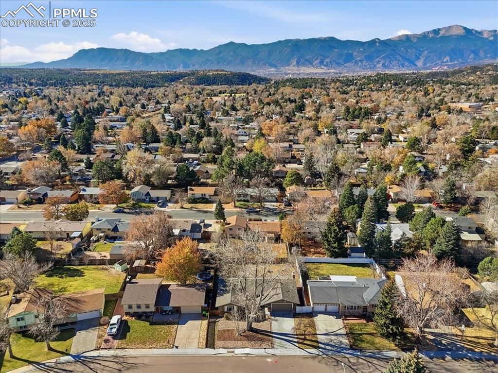 Image 47 of 48: Aerial view of residential area with a mountainous background