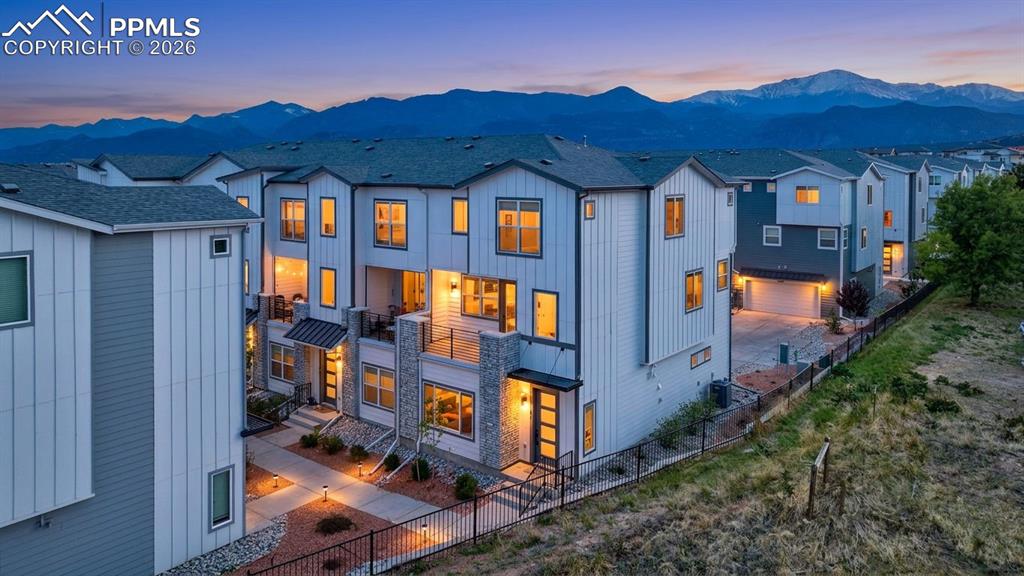 Image 1 of 42: Modern townhome architecture featuring white vertical siding and gray horiz