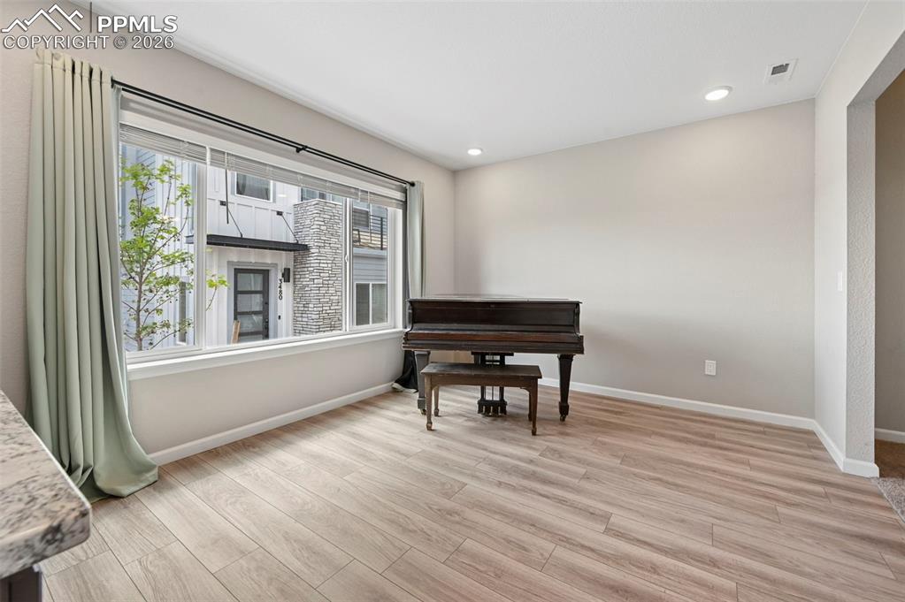 Image 11 of 42: Spacious interior featuring wood-finish flooring, recessed lighting, and a 