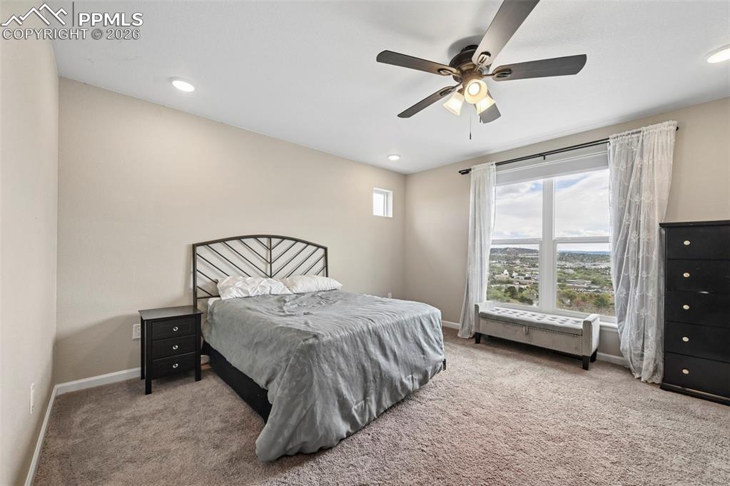 Image 14 of 42: Carpeted bedroom featuring a large window, recessed lighting, and a ceiling