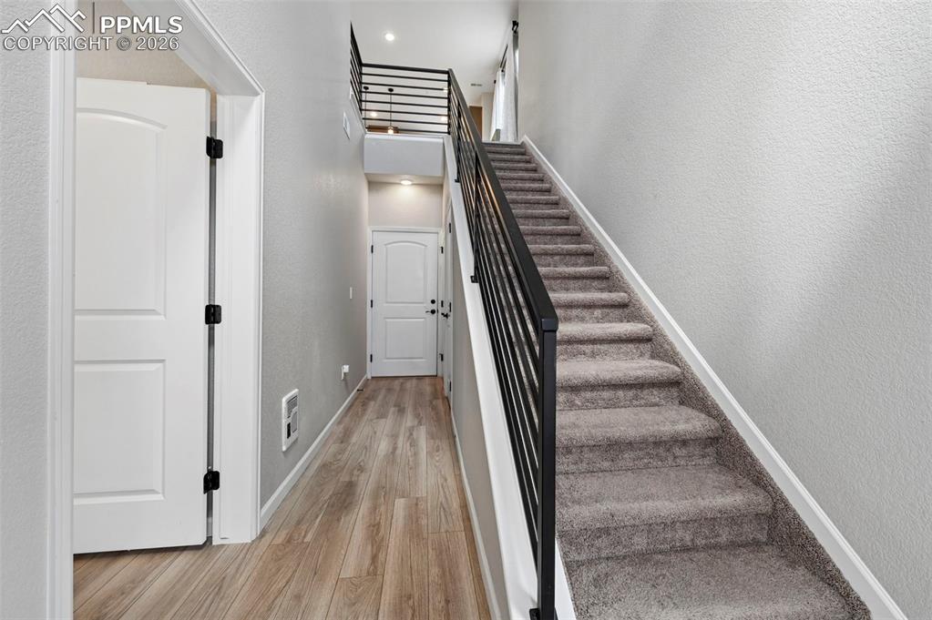 Image 32 of 42: Carpeted staircase featuring a contemporary metal railing