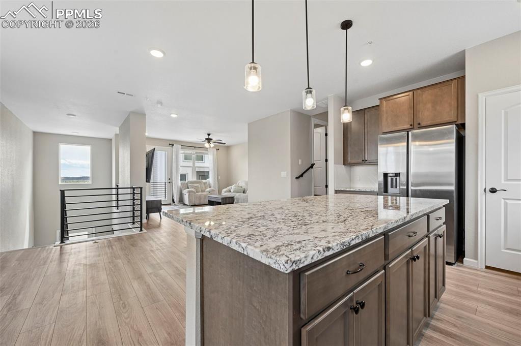 Image 5 of 42: Spacious kitchen island featuring a light-colored granite countertop, penda