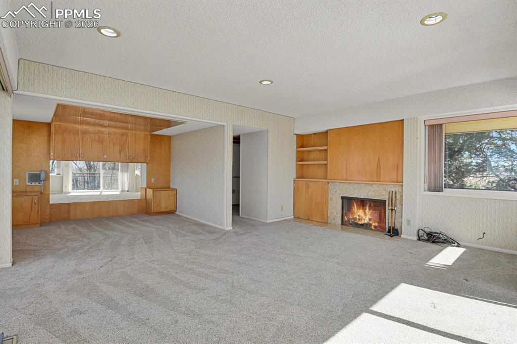 Image 21 of 49: 2nd Level Master Retreat w/wood burning fireplace. *Active fire virtually a