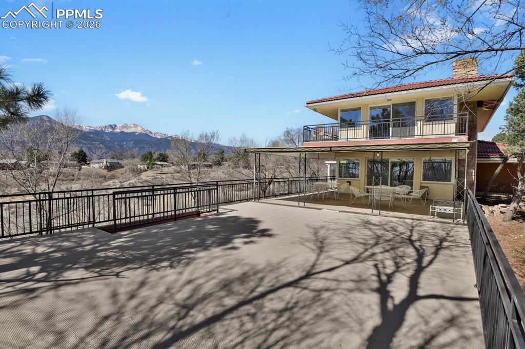 Image 36 of 49: PIKES PEAK VIEWS! HUGE Partially covered 50x24 Deck off Main level Great Ro