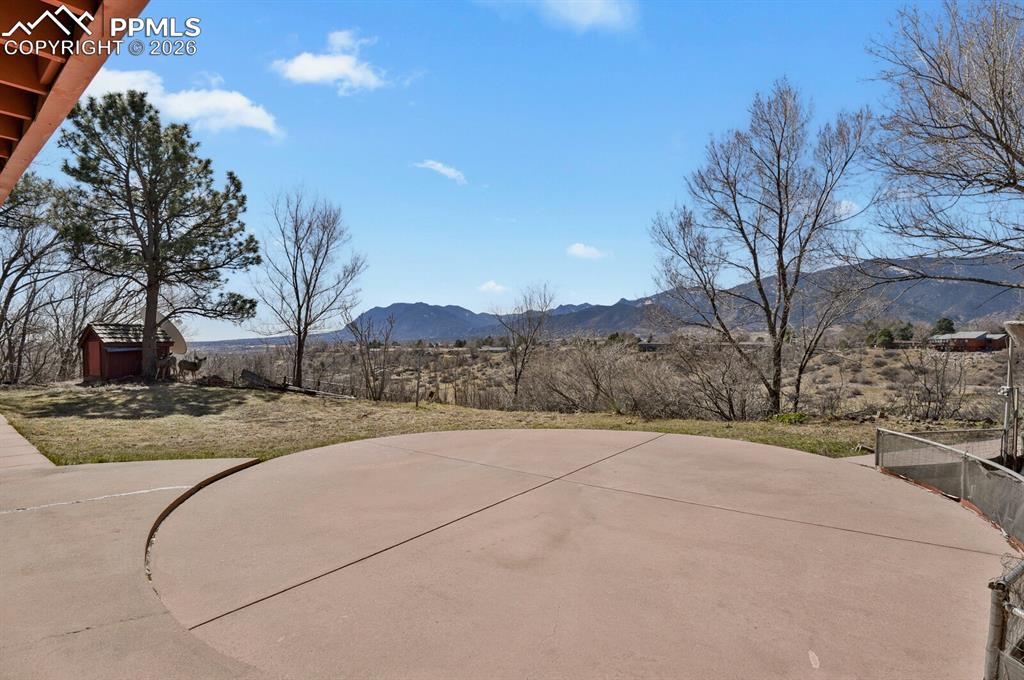 Image 37 of 49: VIEWS VIEWS VIEWS! Massive concrete patio w/level backyard space.