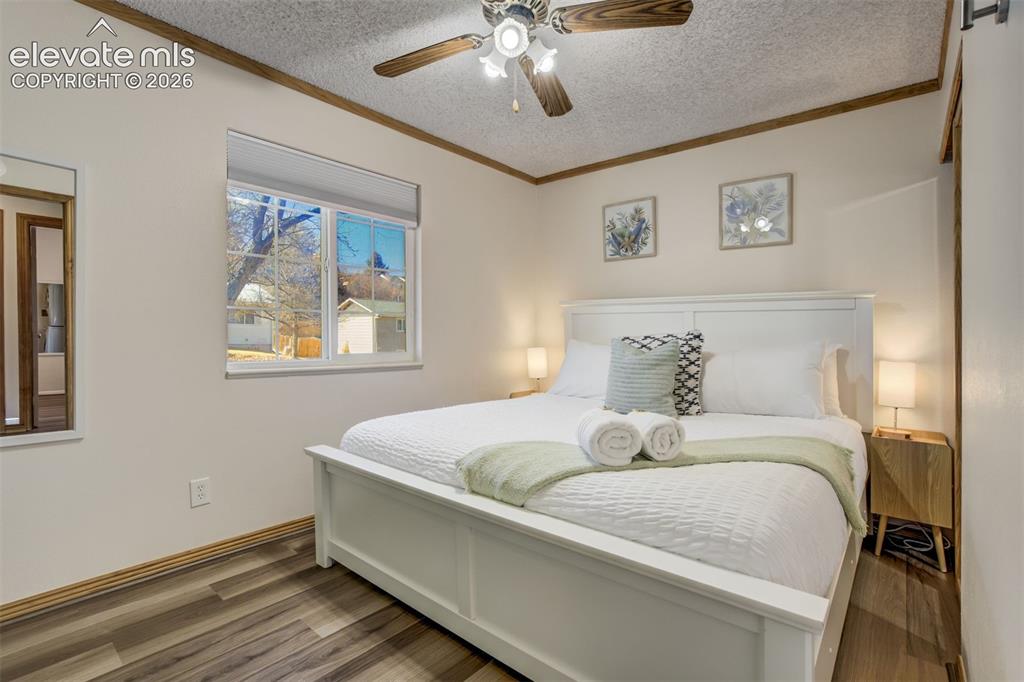 Image 13 of 50: Recessed lighting, wood-finish flooring, ceiling fan, white window trim, an