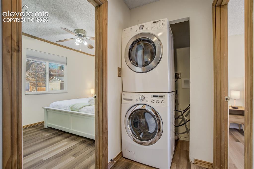 Image 19 of 50: Stacked laundry appliances within a dedicated recess