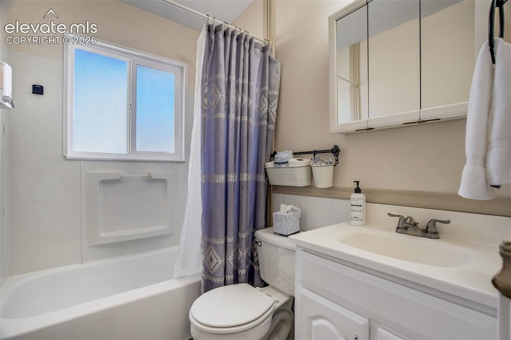 Image 20 of 50: White vanity with an integrated sink and dual-handle faucet