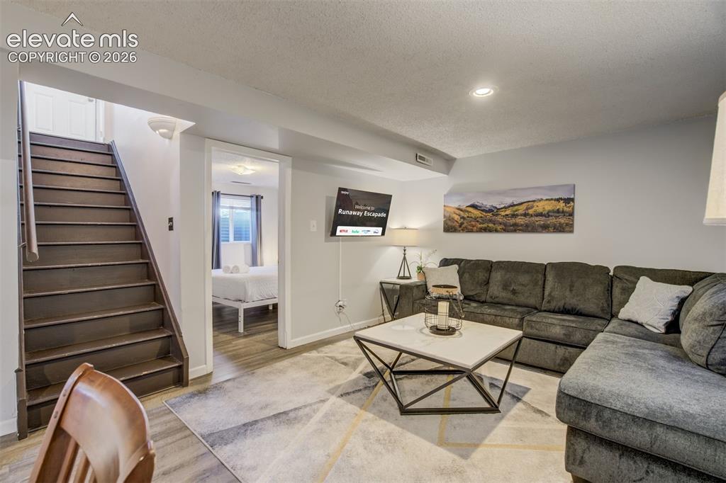 Image 23 of 50: Recessed lighting illuminates the living space featuring light gray walls, 