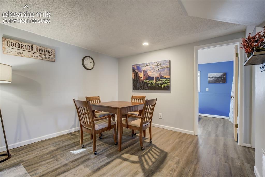 Image 25 of 50: Wood-finish flooring throughout, with white trim and light gray walls