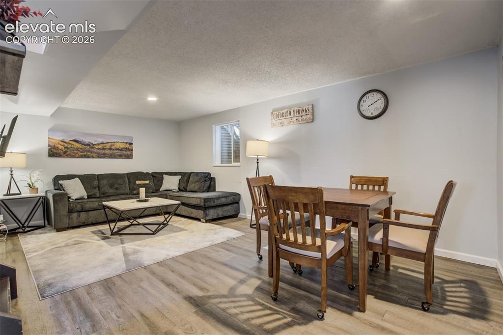 Image 26 of 50: Wood-finish flooring throughout, light gray wall finishes, and recessed cei