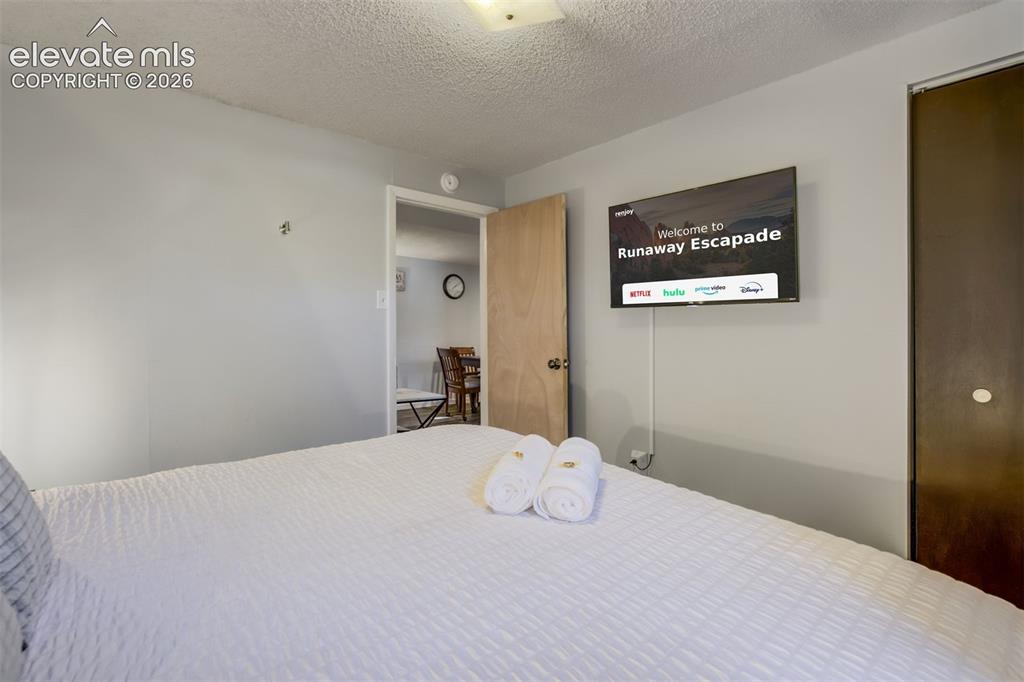 Image 30 of 50: Wall-mounted display, light gray wall finish, and wood-finish door