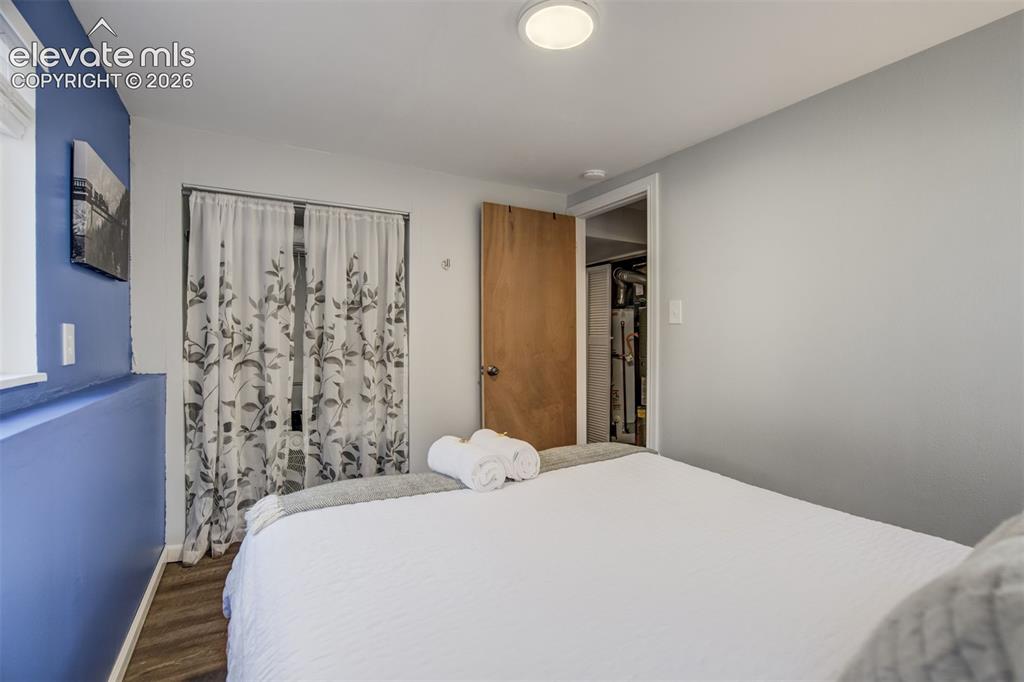 Image 33 of 50: Recessed lighting, wood-finish flooring, and a solid core interior door