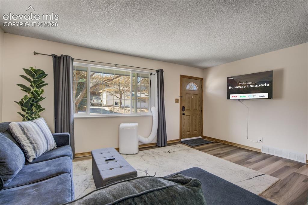 Image 7 of 50: Wood-finish flooring throughout