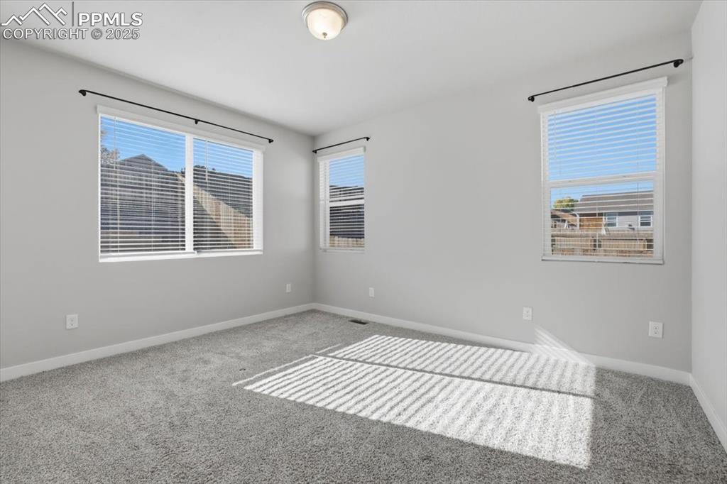 Image 14 of 34: Carpeted spare room with baseboards