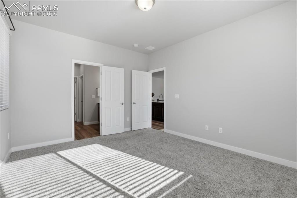Image 15 of 34: Unfurnished bedroom featuring carpet and baseboards