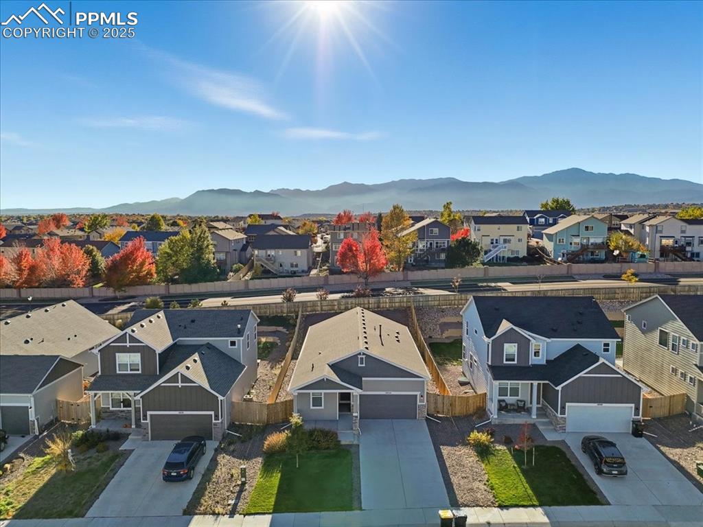 Image 2 of 34: Aerial view of residential area with a mountain backdrop