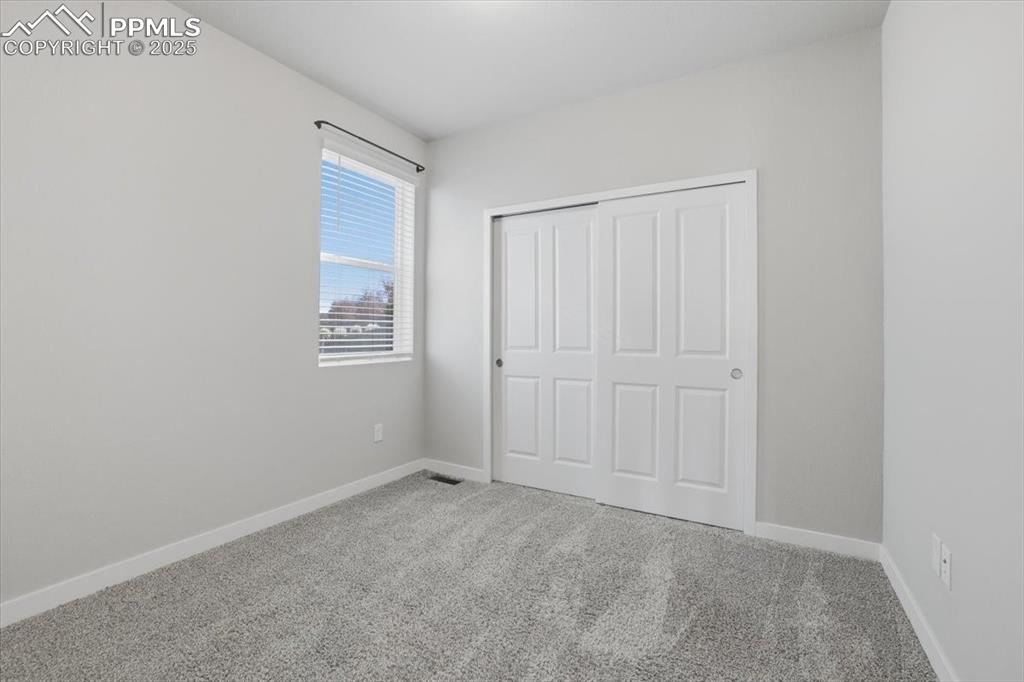 Image 23 of 34: Unfurnished bedroom featuring carpet flooring and a closet