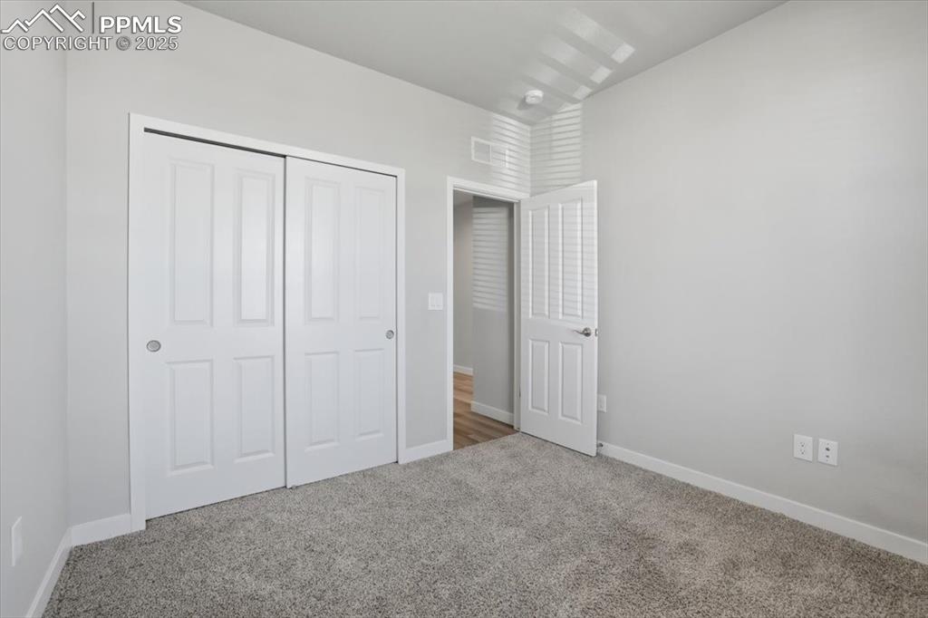 Image 24 of 34: Unfurnished bedroom featuring carpet flooring and a closet