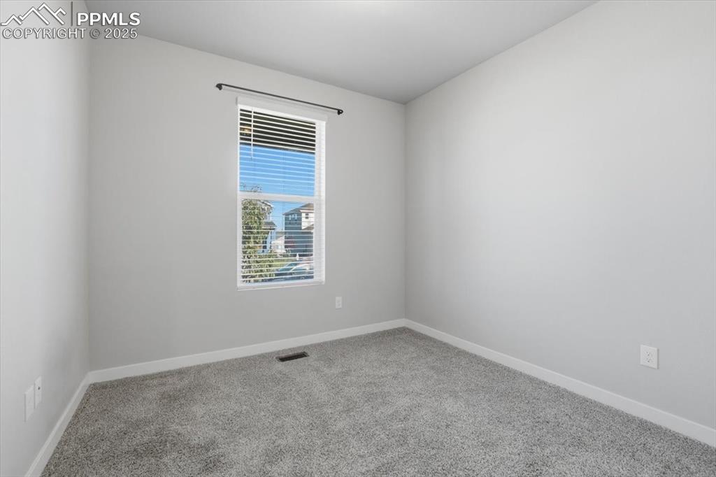 Image 25 of 34: Carpeted spare room with baseboards