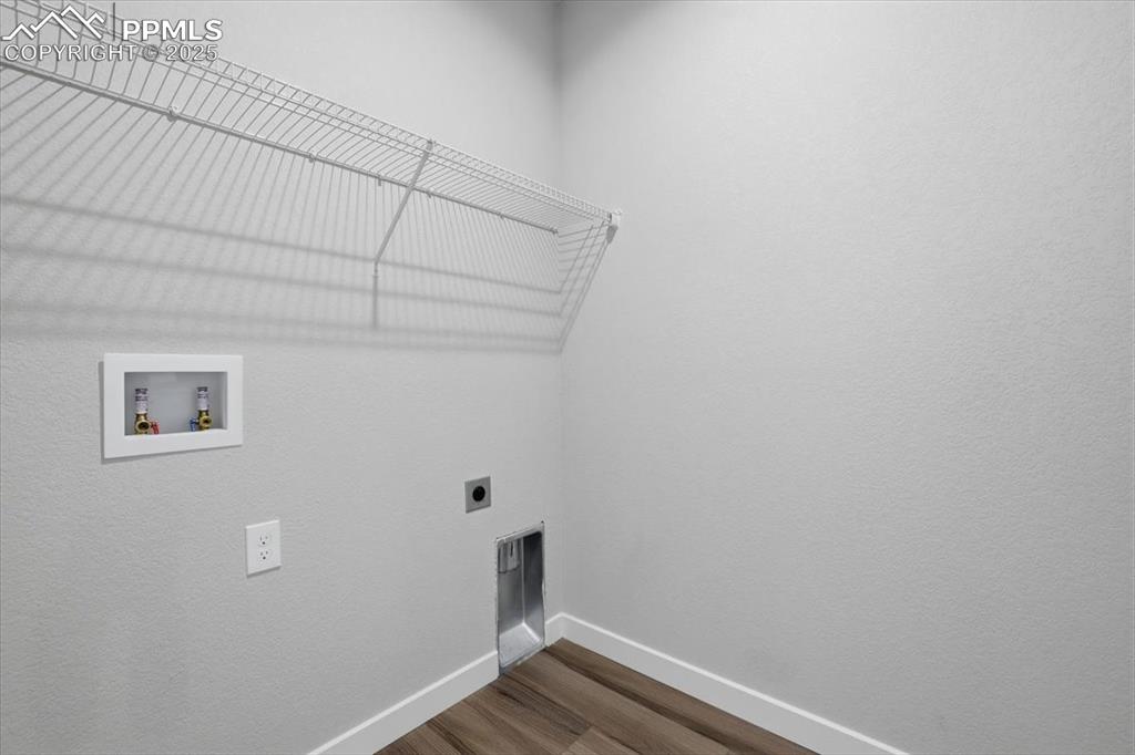 Image 27 of 34: Laundry room featuring wood finished floors, hookup for an electric dryer, 