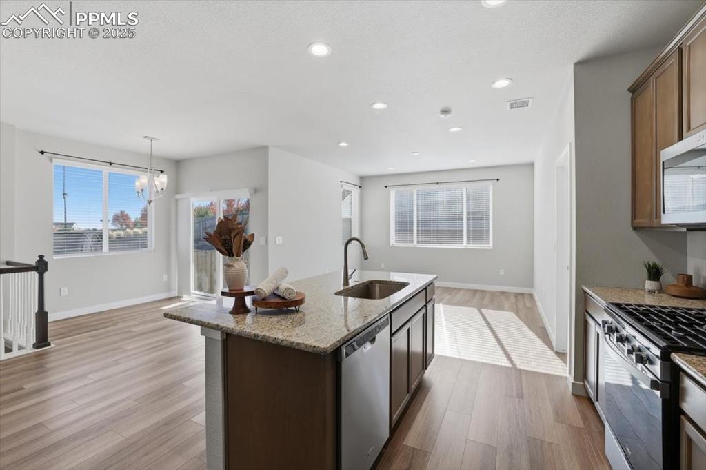 Image 9 of 34: Kitchen featuring appliances with stainless steel finishes, dark wood-style