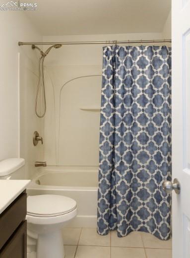 Image 7 of 9: Bathroom featuring vanity, light tile patterned flooring, and shower / tub 