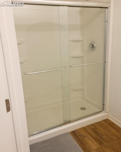 Image 9 of 9: Full bath featuring wood finished floors and a stall shower