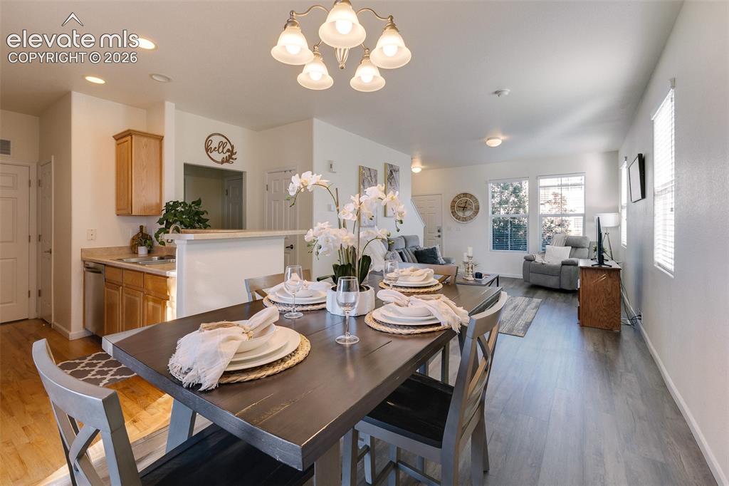 Image 11 of 36: Open-concept living space featuring wood-finish flooring, recessed lighting