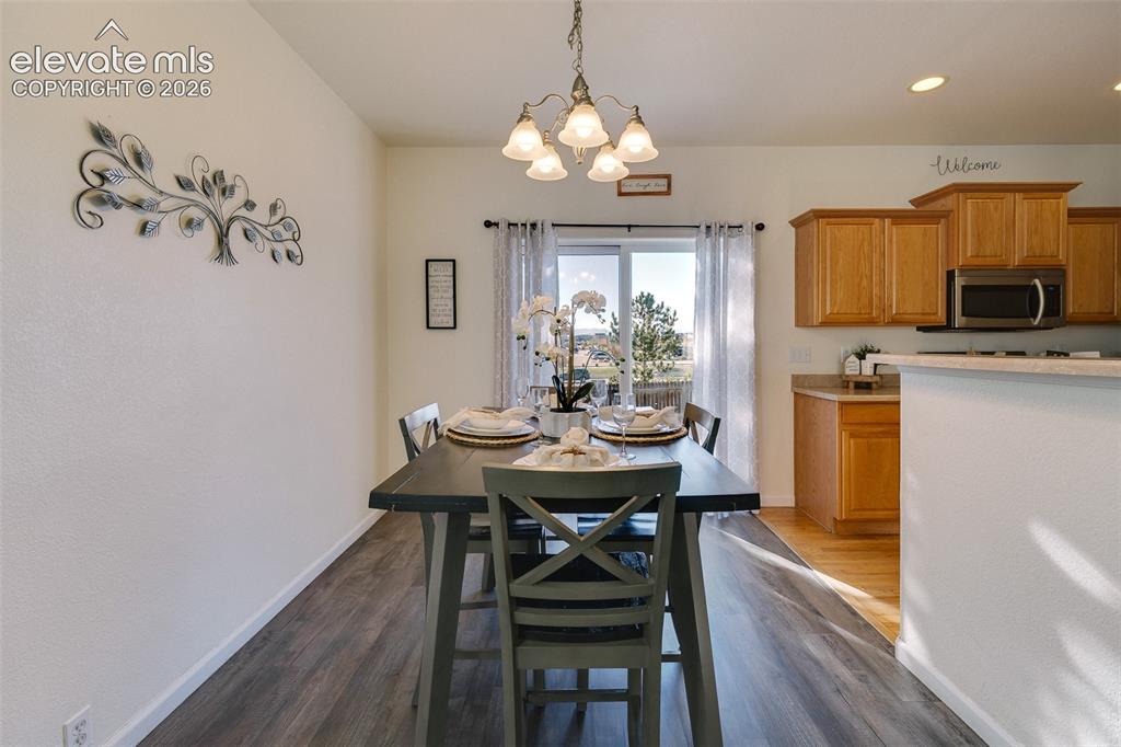 Image 12 of 36: Wood-finish flooring throughout, with a sliding glass door providing access