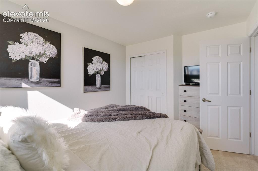 Image 25 of 36: White interior door with brushed nickel hardware, white bi-fold closet door
