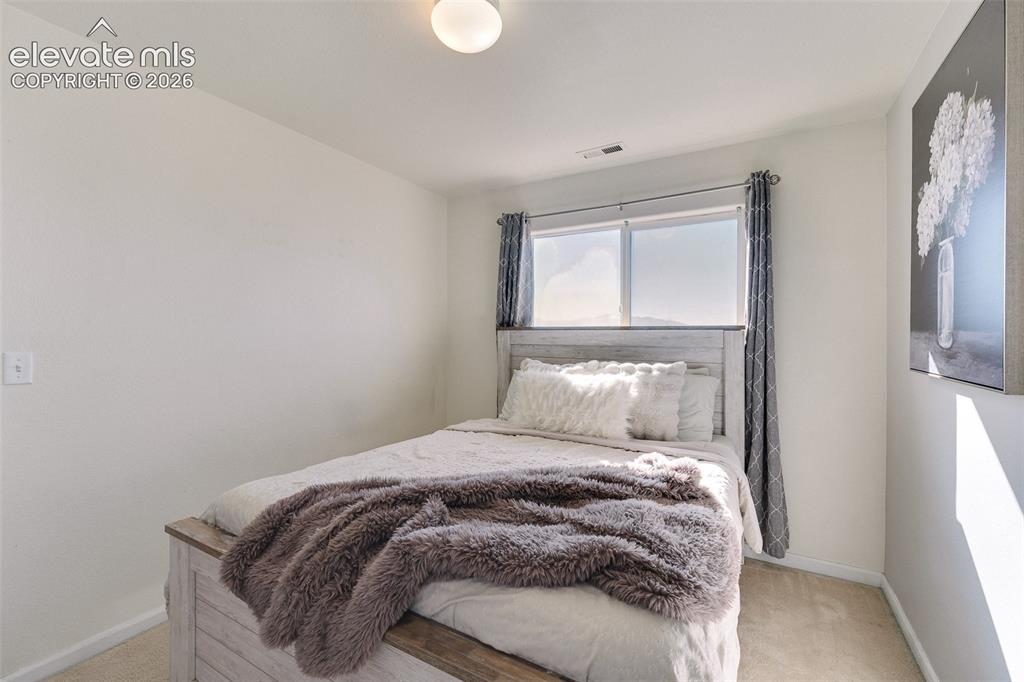 Image 26 of 36: Bright interior space with light-toned walls, a window offering natural lig