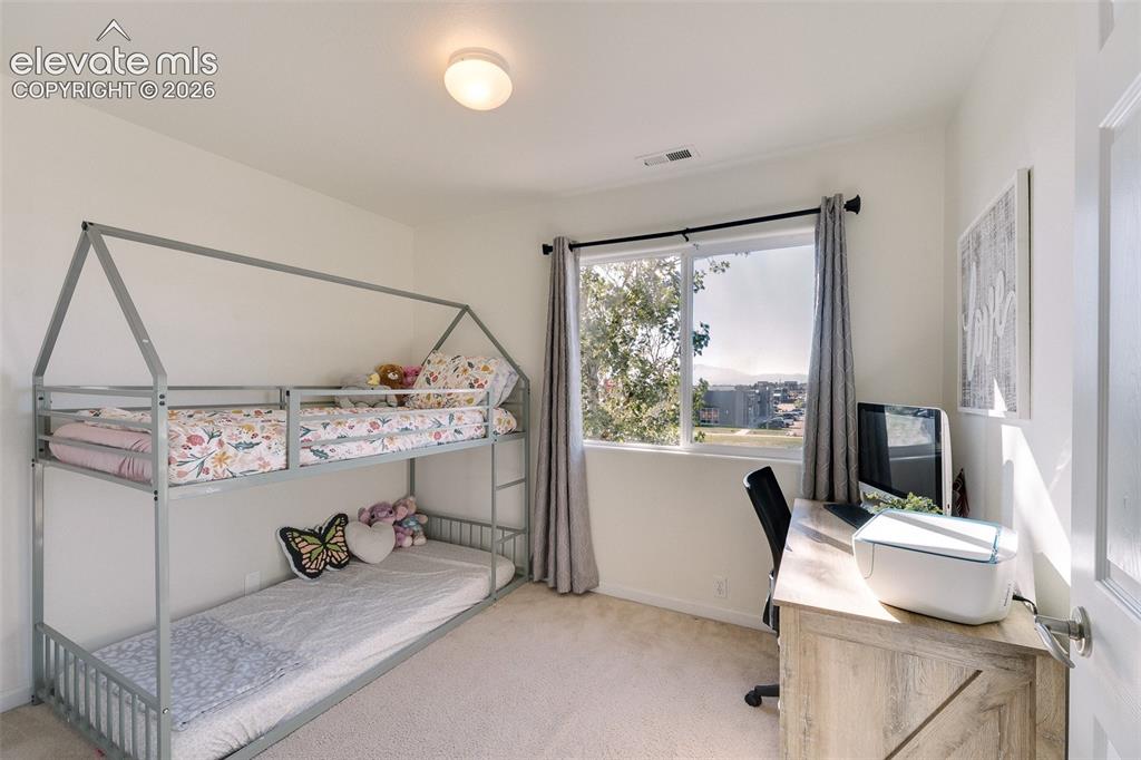 Image 28 of 36: Recessed lighting, large window with outdoor scenery, light-toned carpeting