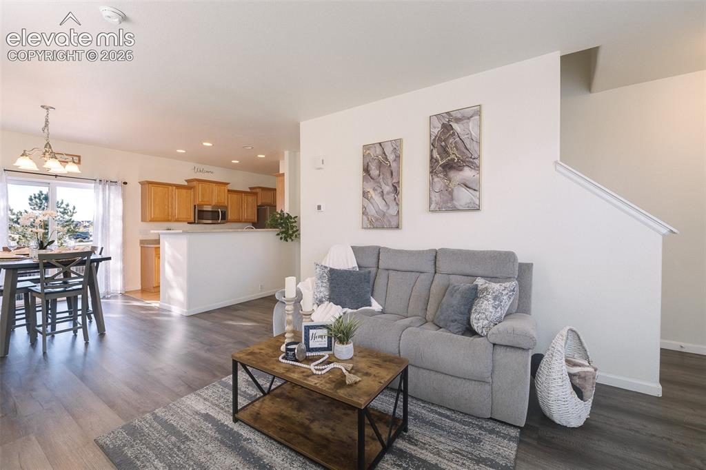 Image 4 of 36: Open-concept main level featuring wood-finish flooring, a dining area with 