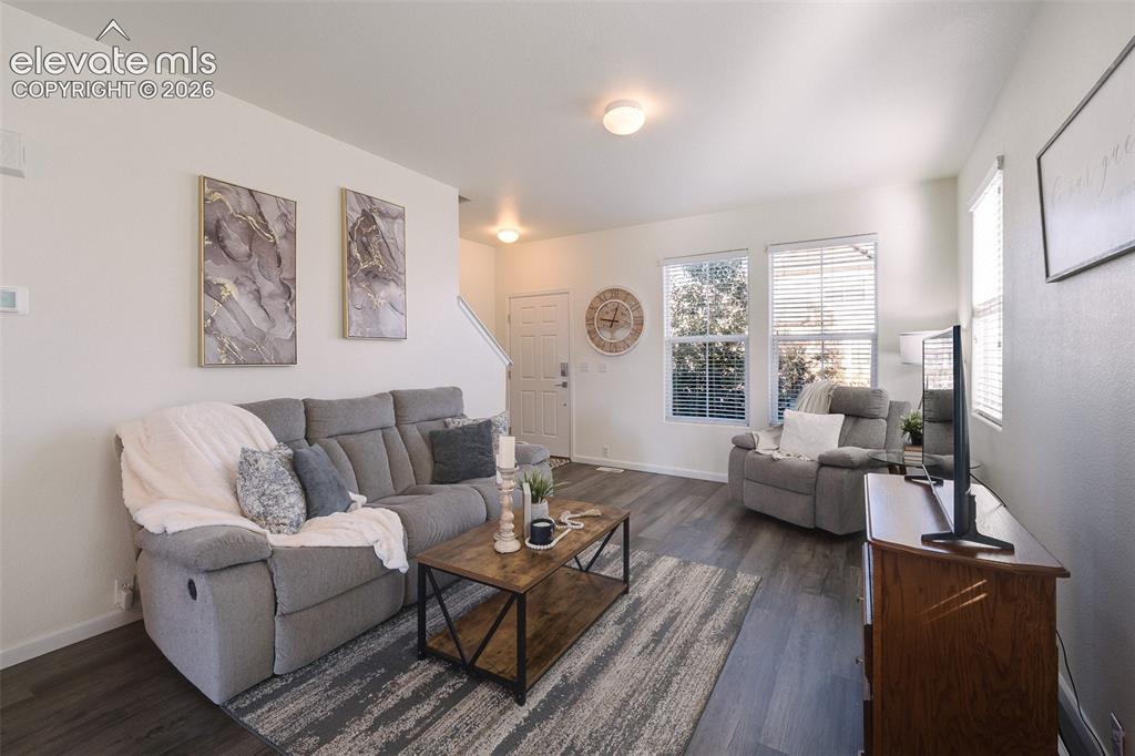 Image 8 of 36: Wood-finish flooring throughout, multiple windows with blinds, recessed lig