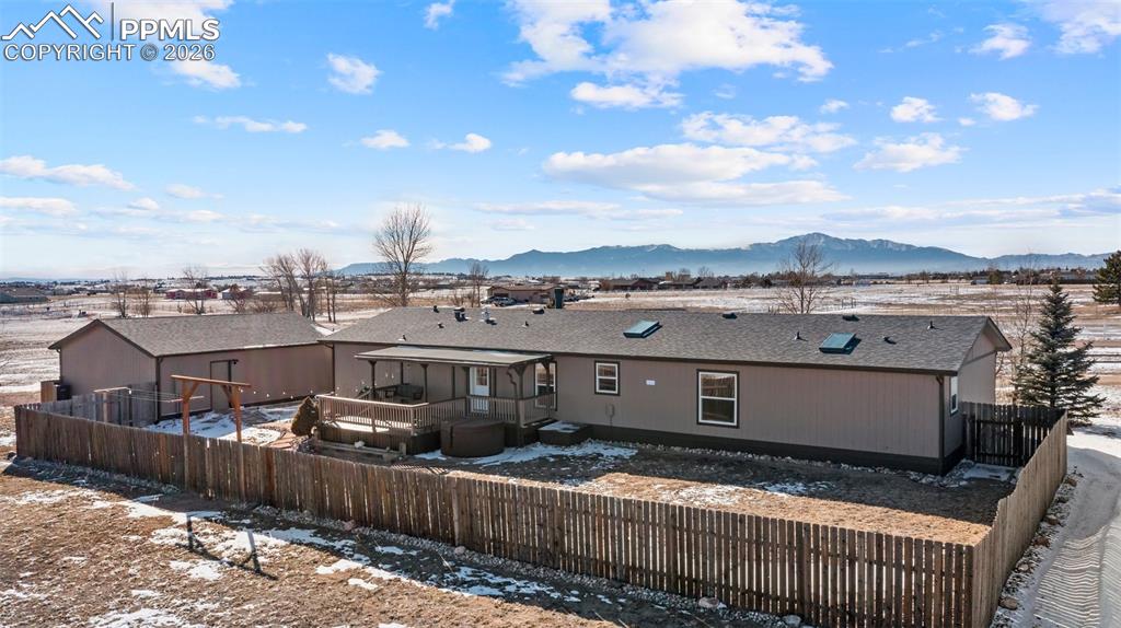 Image 15 of 50: Snow covered property with a mountain view and a sunroom