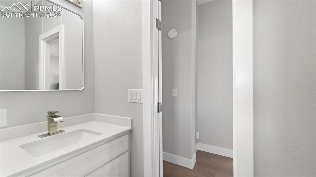 Image 42 of 50: Bathroom with hardwood / wood-style flooring and vanity