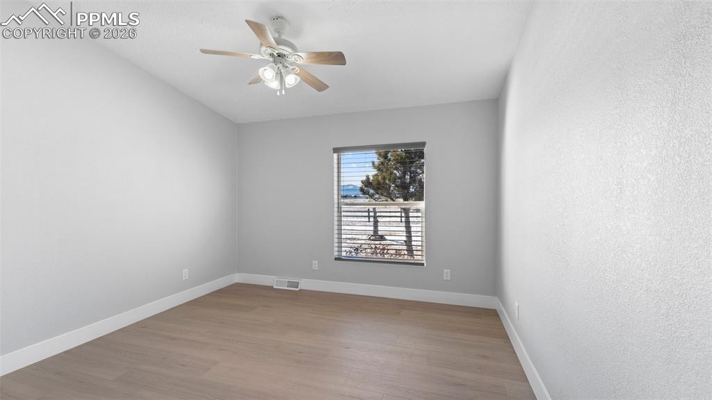 Image 46 of 50: Spare room with light hardwood / wood-style floors and ceiling fan