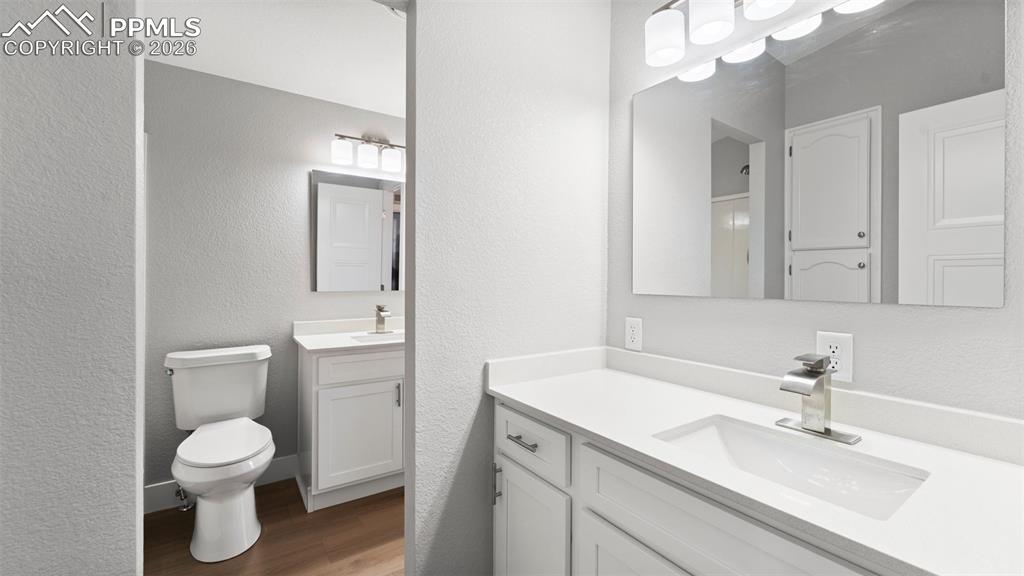Image 47 of 50: Bathroom with vanity, wood-type flooring, and toilet