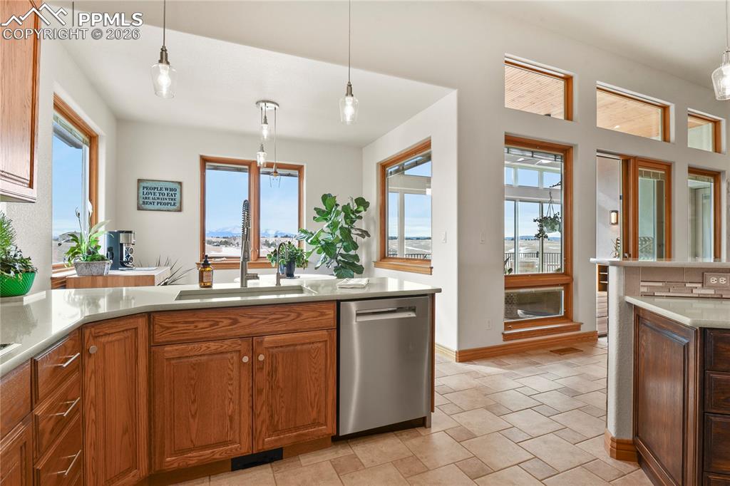Image 10 of 50: View to the eating nook and expansive windows with Pikes Peak views