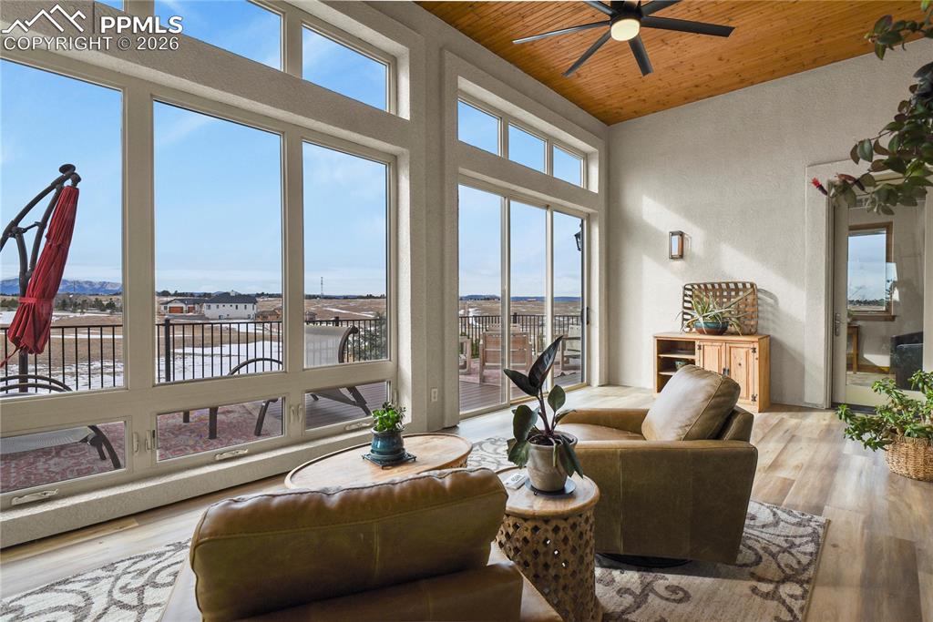 Image 13 of 50: Enclosed sunroom with new LVP flooring and views!