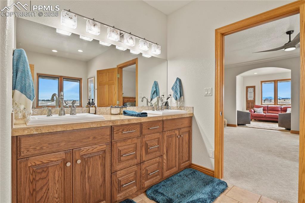 Image 17 of 50: Primary suite bathroom with double sinks, new lighting
